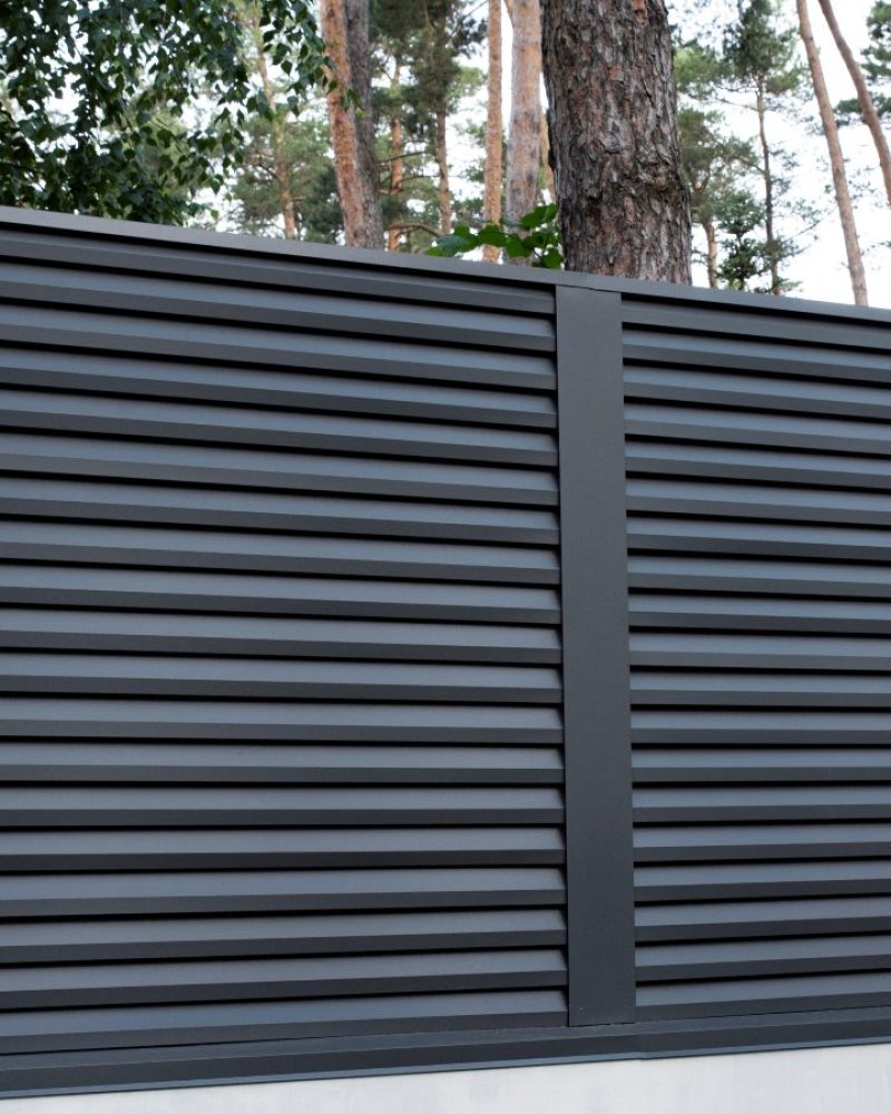 Modern gray metal fence with shutters blinds